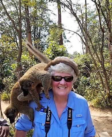 Cynthia with two lemurs on her shoulder