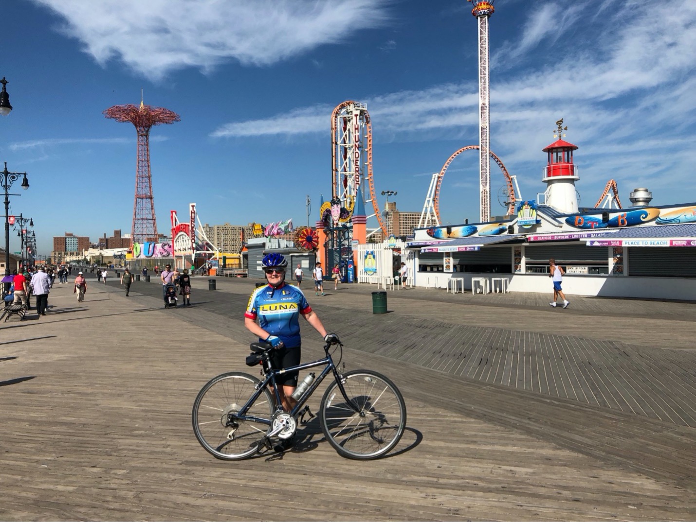 Woman in cycling gear posing with her bike