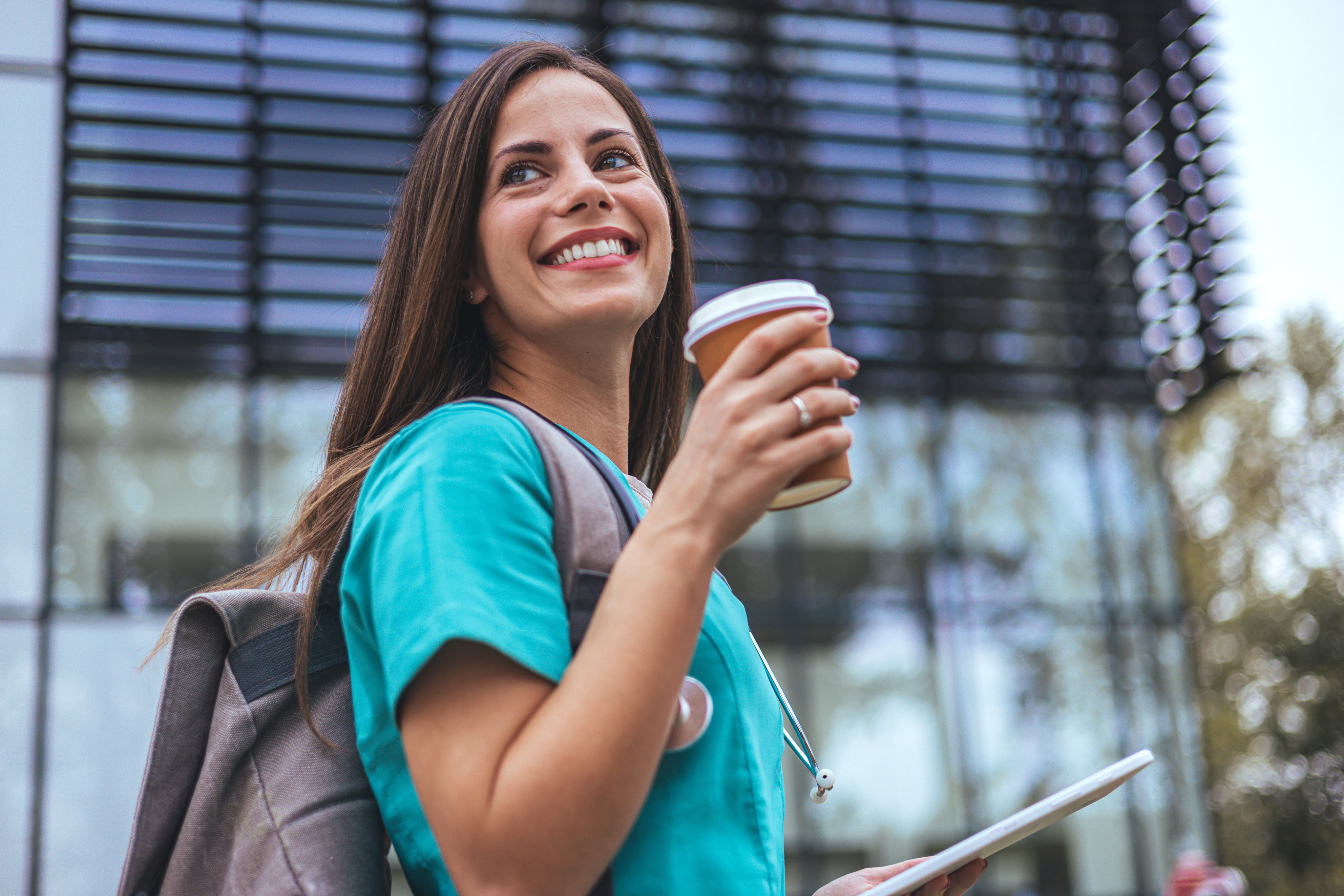 smiling nurse holding coffee cup