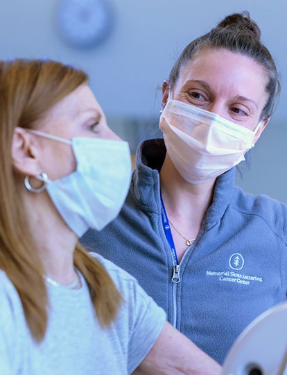 Colleague in MSK Fleece chatting to a patient